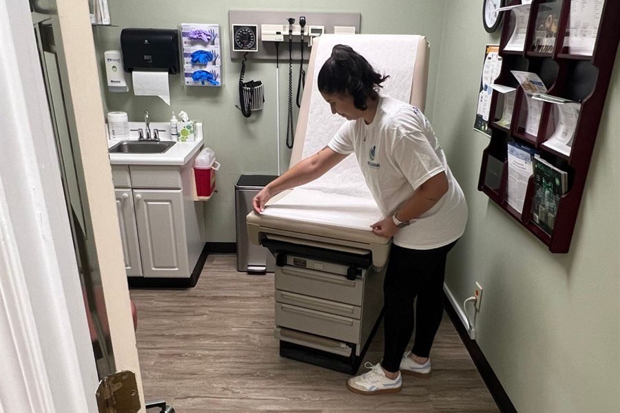 Starbiz staff member cleaning an exam table in a metro Atlanta medical office
