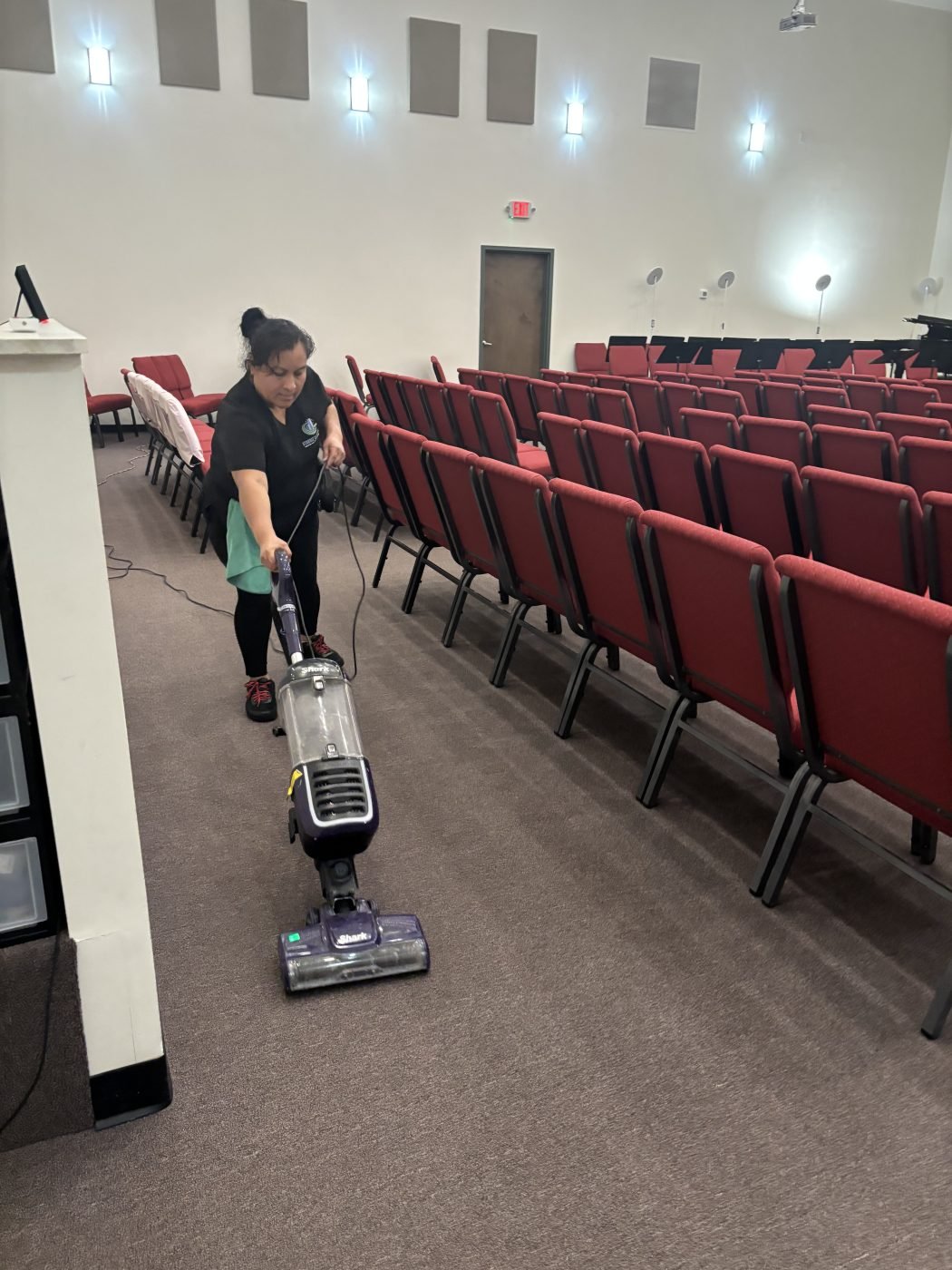 Starbiz cleaner vacuuming church carpet